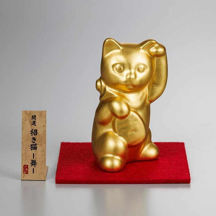 Gold maneki neko lucky cat figurine with raised paw on red mat | Kanazawa gold leaf, Hakuichi