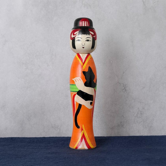 Taisho-style kokeshi wooden doll in orange kimono holding a black cat | Tsuchiyu, Fukushima, Konno Akihiro