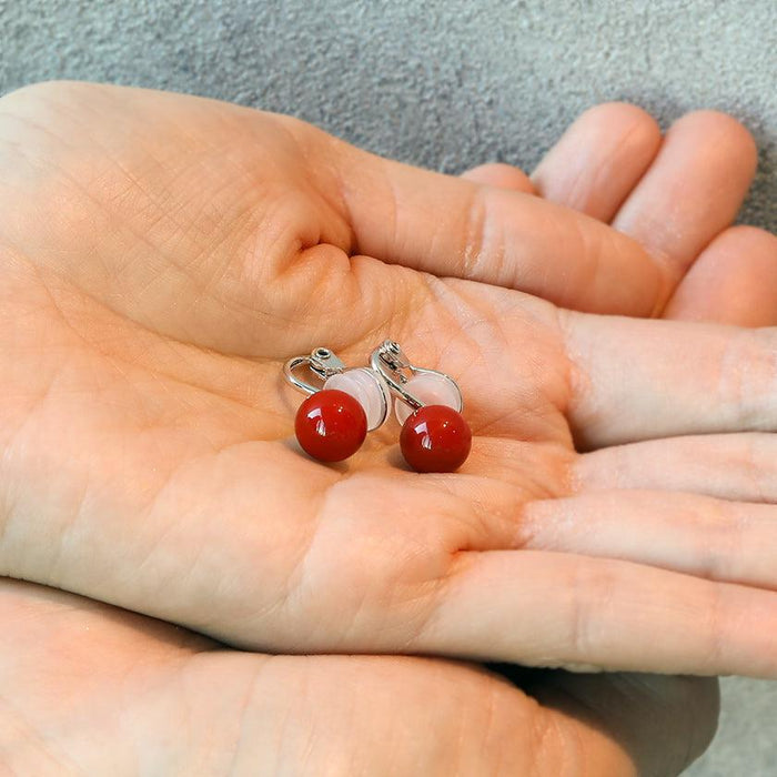 Clip-on earrings for both ears.
