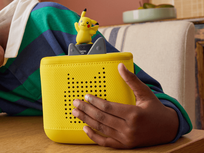 child holding the Pokémon Pikachu Tonie and a toniebox 2