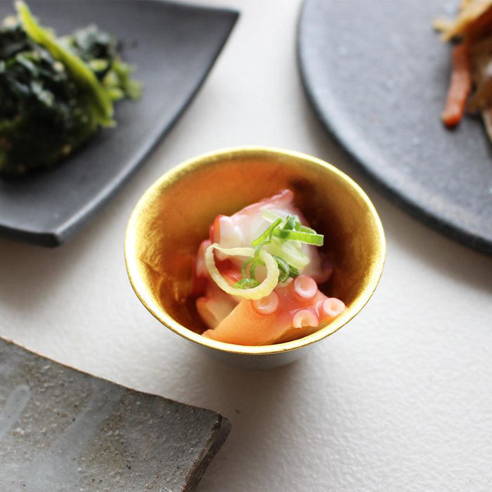 Gold leaf tin sake cup holding octopus appetizer in Japanese table setting | Nousaku, Takaoka