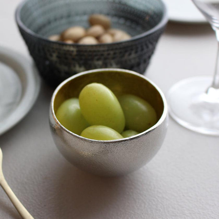Tin sake cup holding fresh green grapes on a table setting | Takaoka casting, Nousaku