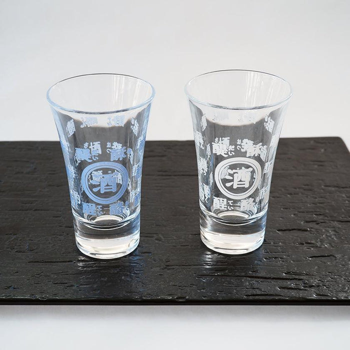 Pair of sake glasses with etched Japanese kanji characters on dark slate | Mino, Marumo Takagi