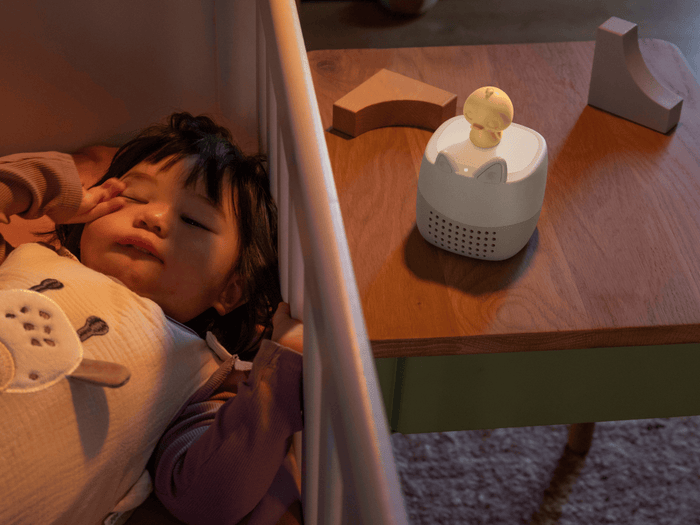 child laying next to the Toniebox Lite Sleepy Friends Set