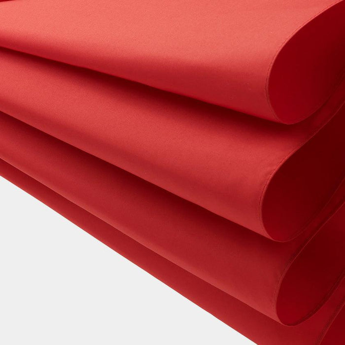 Folded red fabric material, smooth matte finish, close-up detail shot
