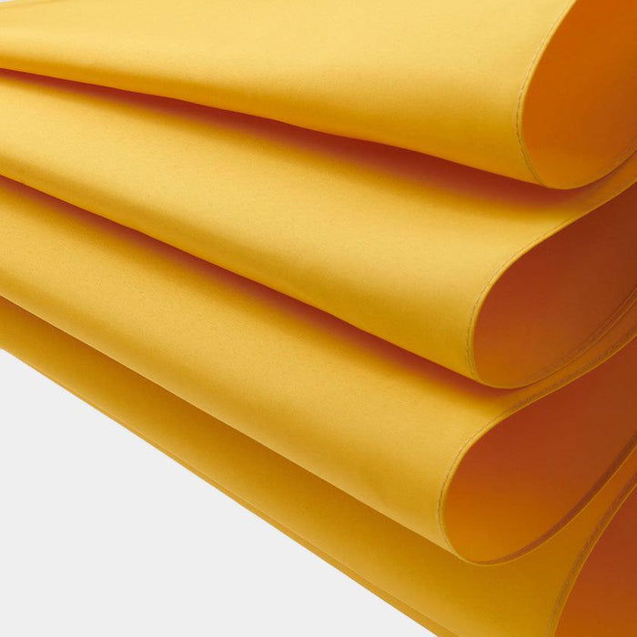 Stacked golden-yellow silk fabric panels, material detail for Tokyo umbrella craft | Maehara Koei Shoten